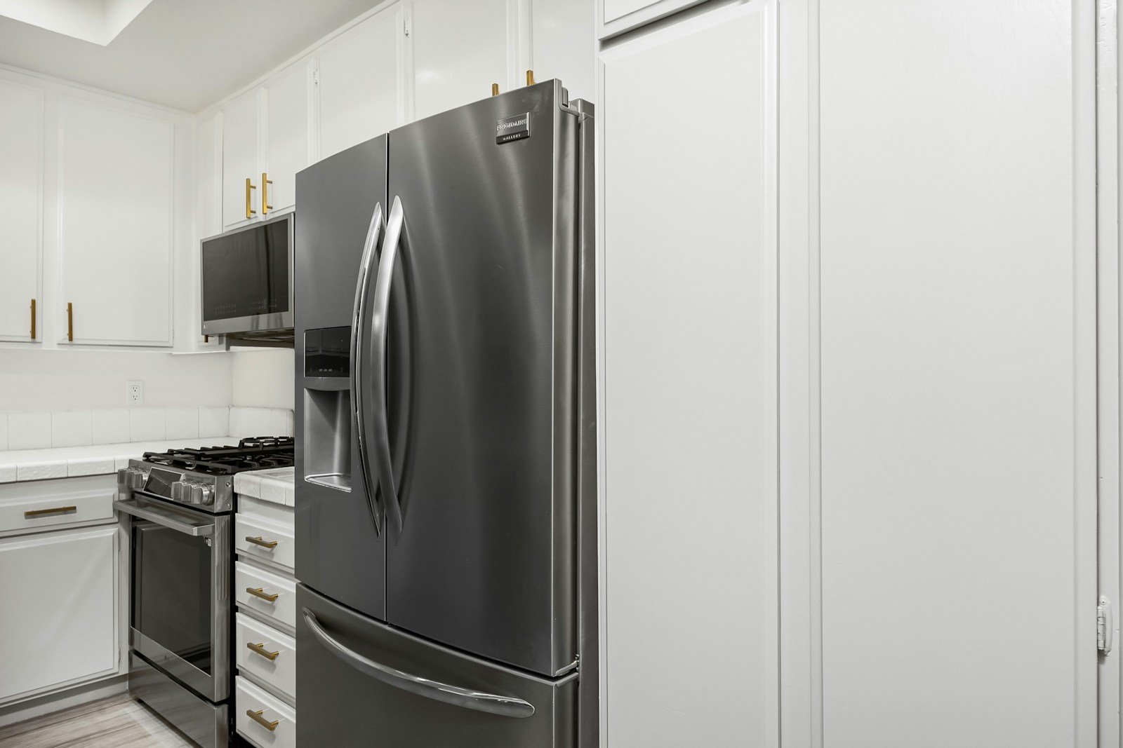 Modern kitchen with refrigerators, range, and appliances we service