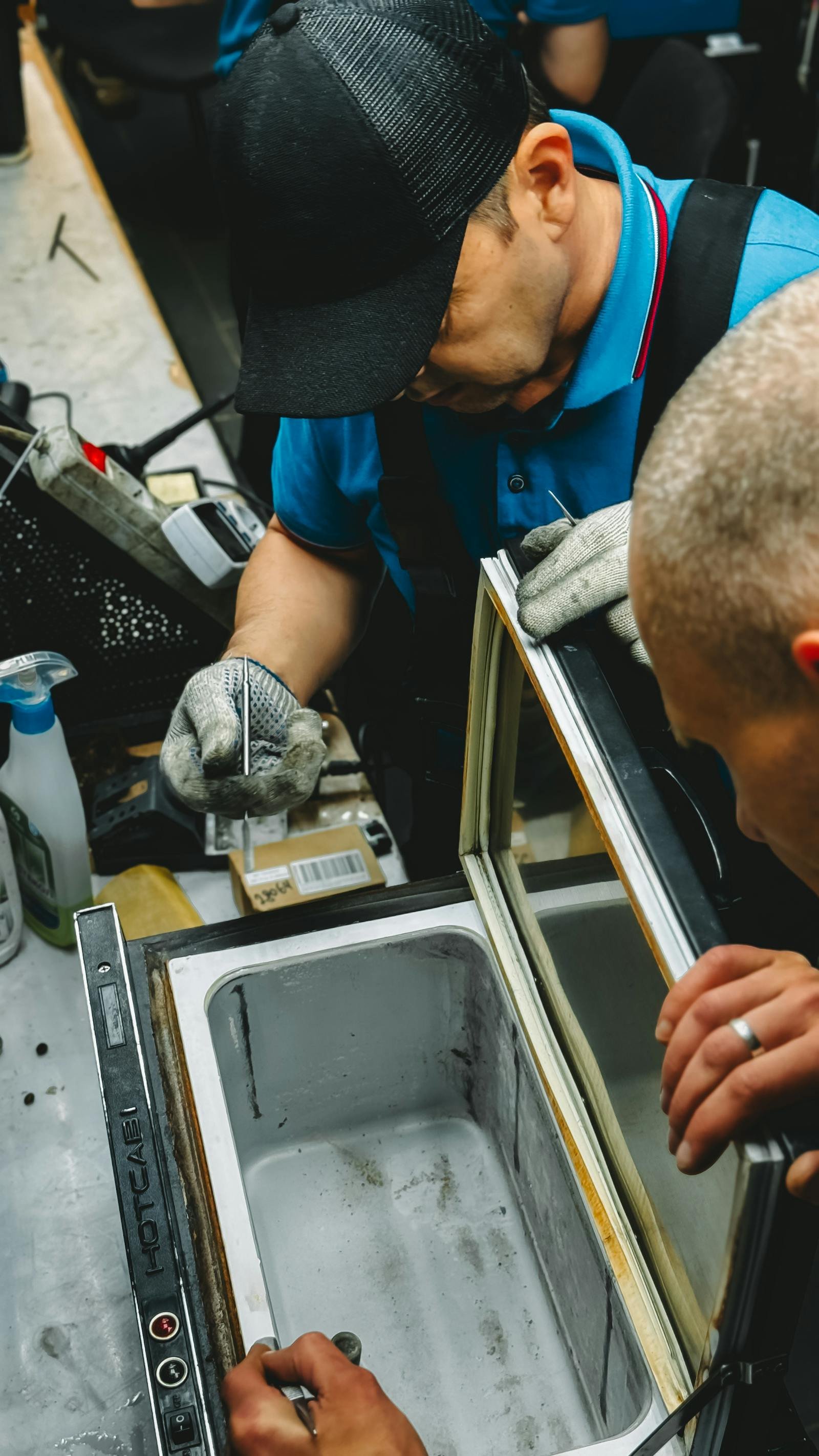 Technicians working together on appliance diagnostics