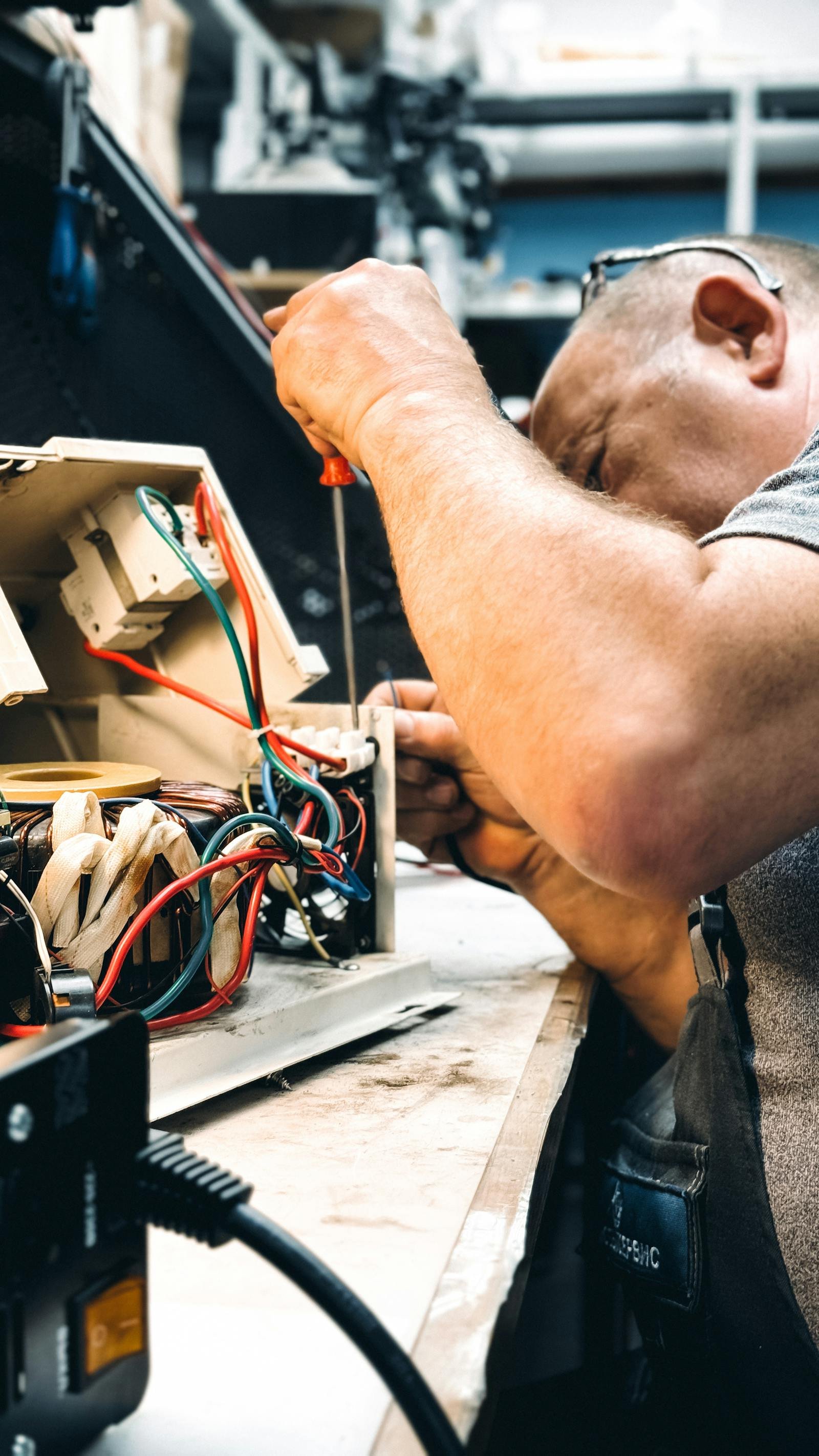 Technician troubleshooting and repairing Dishwasher Repair