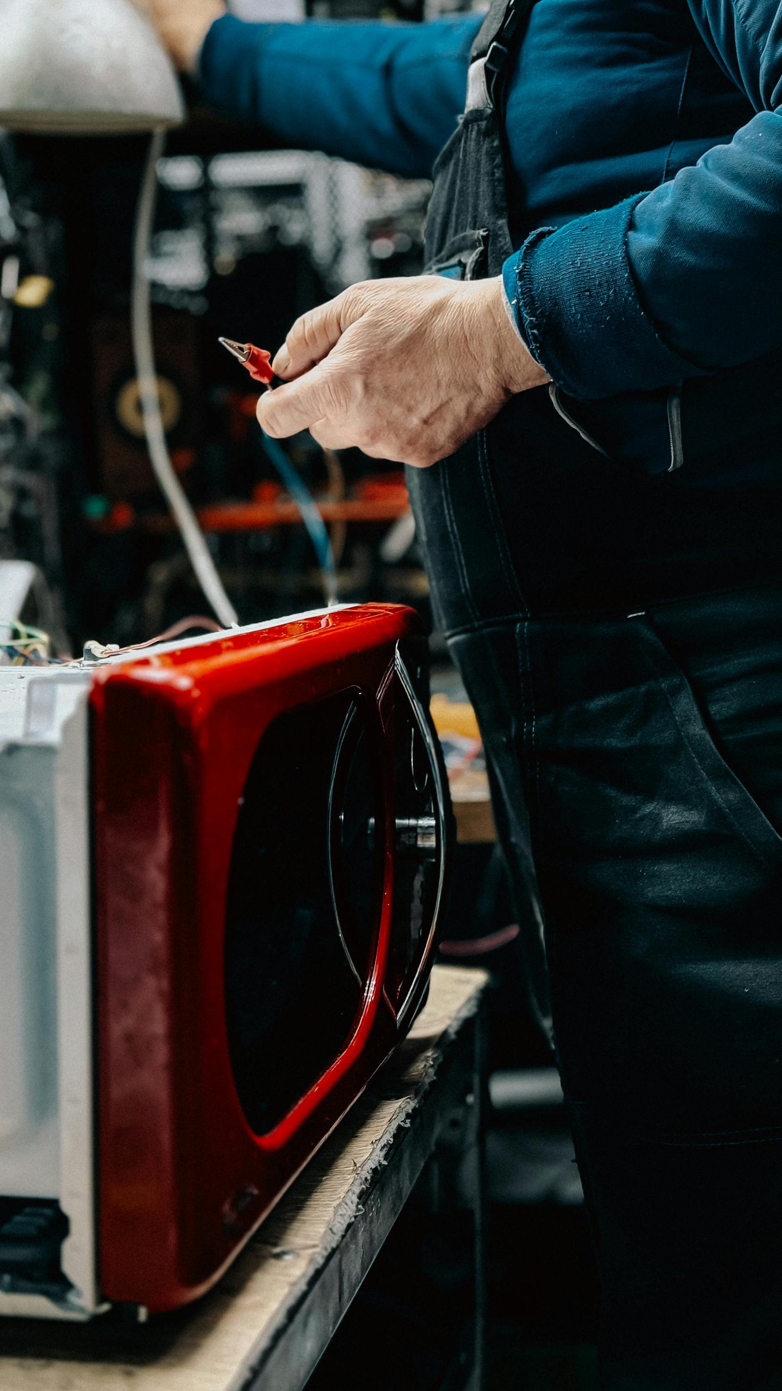 Technician troubleshooting and repairing Microwave Repair